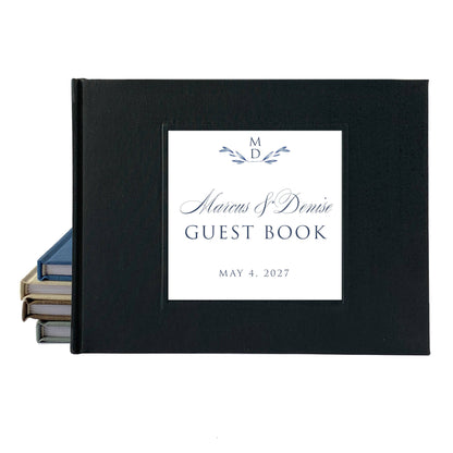 Black linen wedding guest book with personalized title and date in script font on a white background