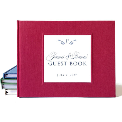 Burgundy linen wedding guest book with a traditional design using elegant script for the bride and groom's names.