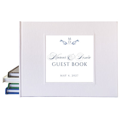 Personalized white linen wedding guest book with traditional script font used for the bride and groom's names.