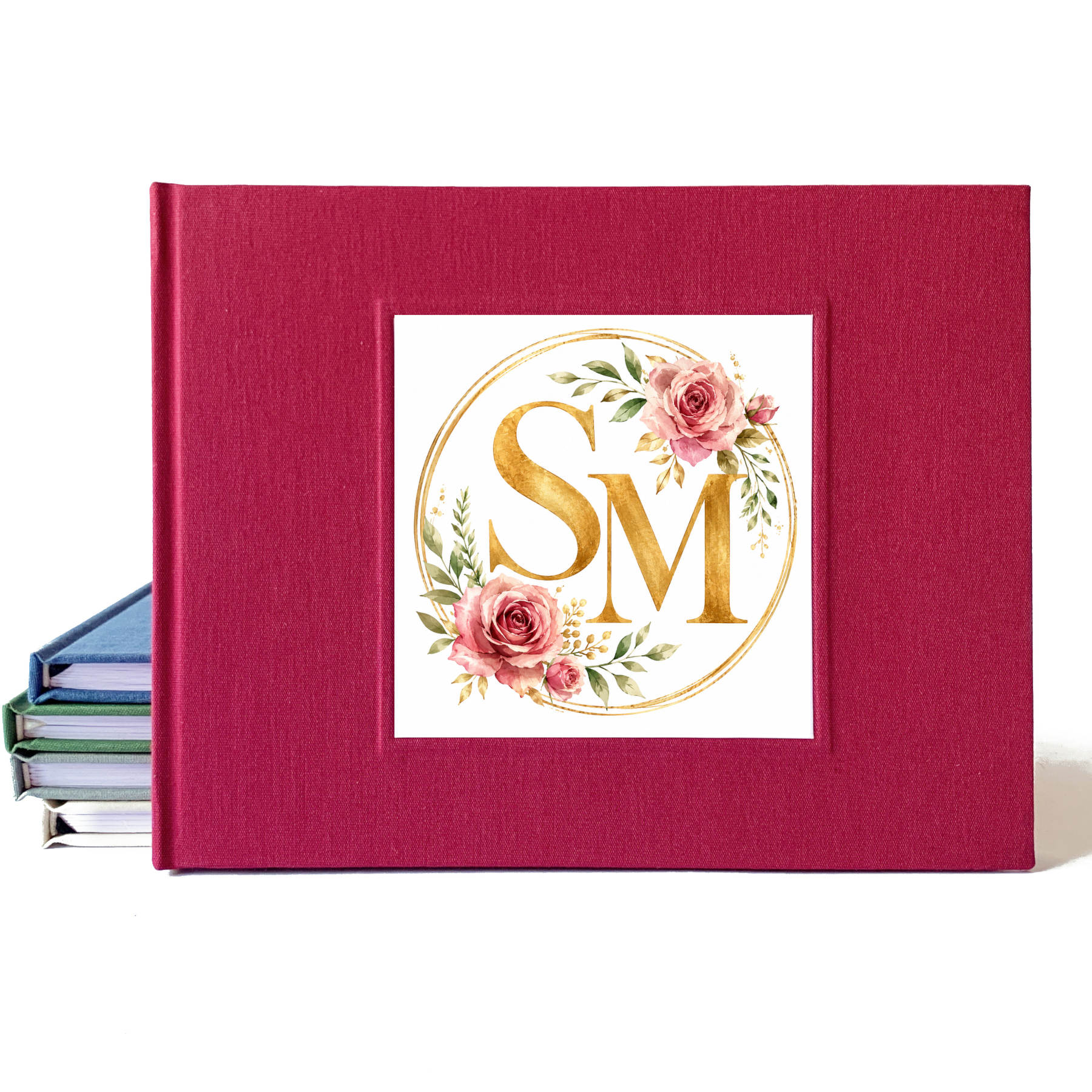 Burgundy linen wedding guest book with a rose and gold watercolor wedding crest design on the cover.