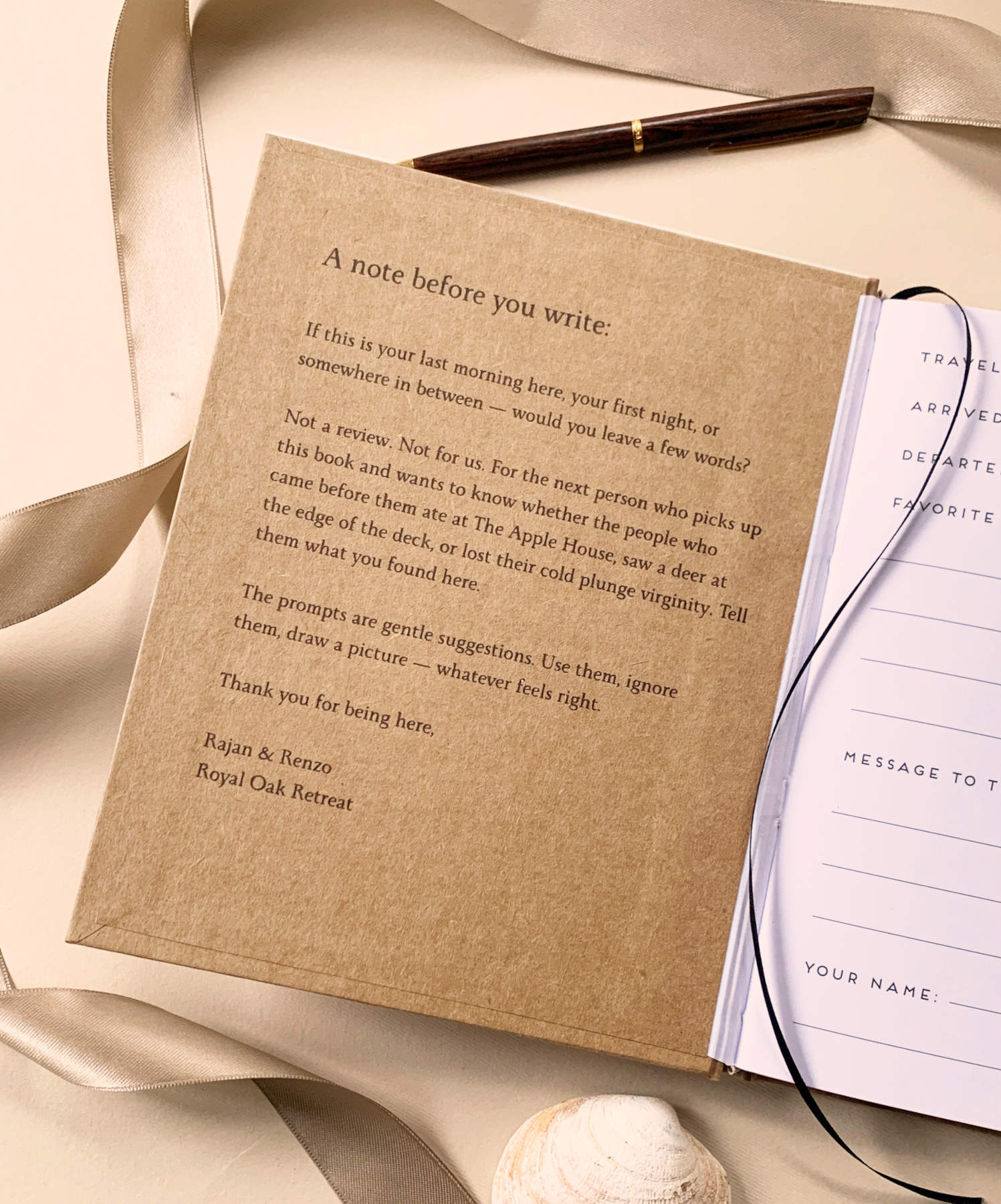 Open book with welcome message for guests custom printed on the inside front cover, resting on a table with a  pen, ribbon and a seashell.